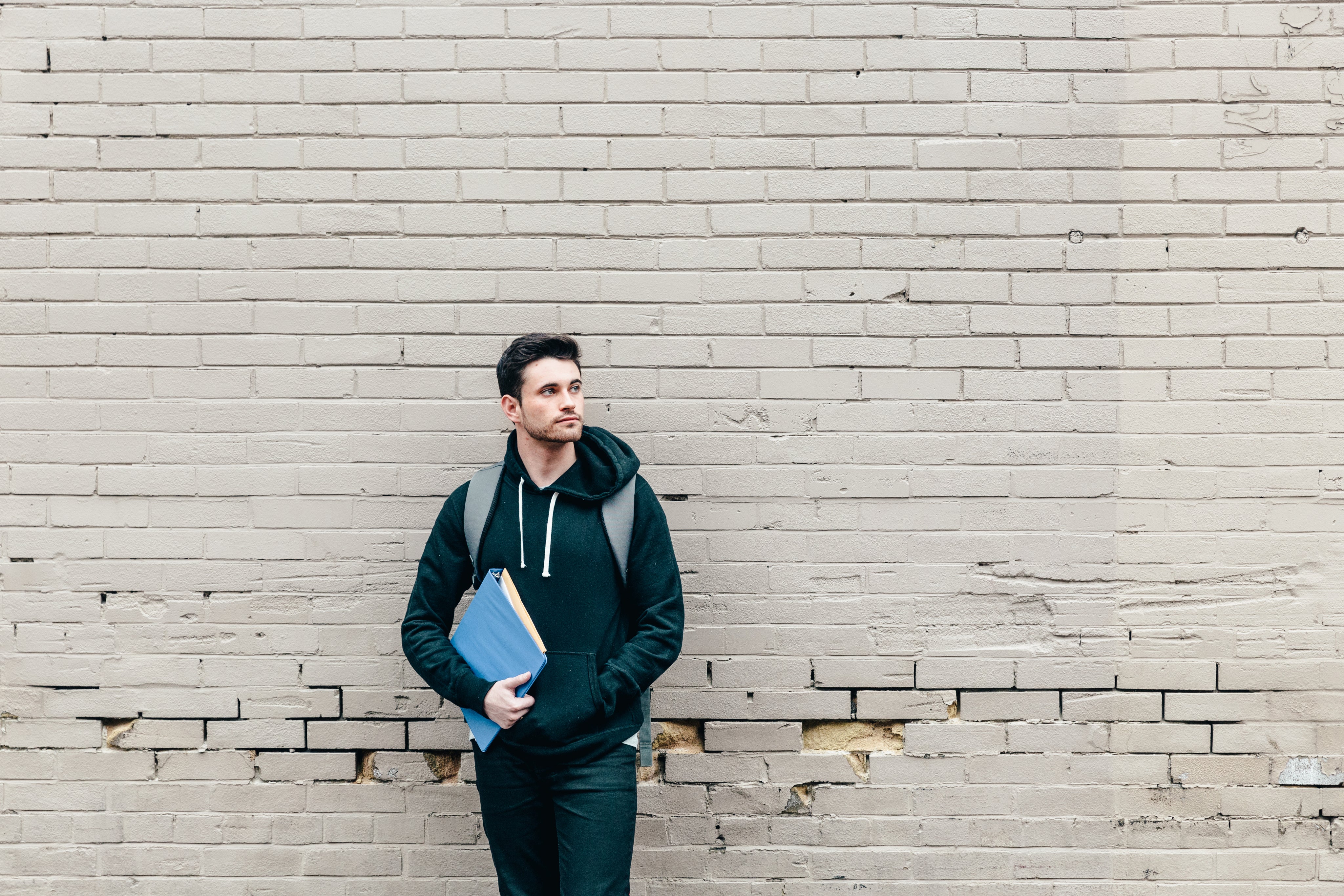 files/student-leaning-against-brick-wall.jpg